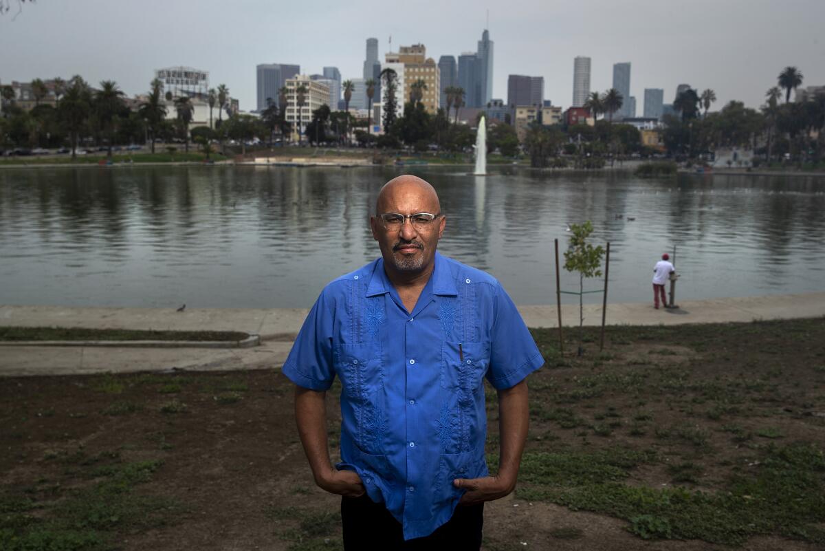 Author Roberto Lovato stands before MacArthur Park Lake