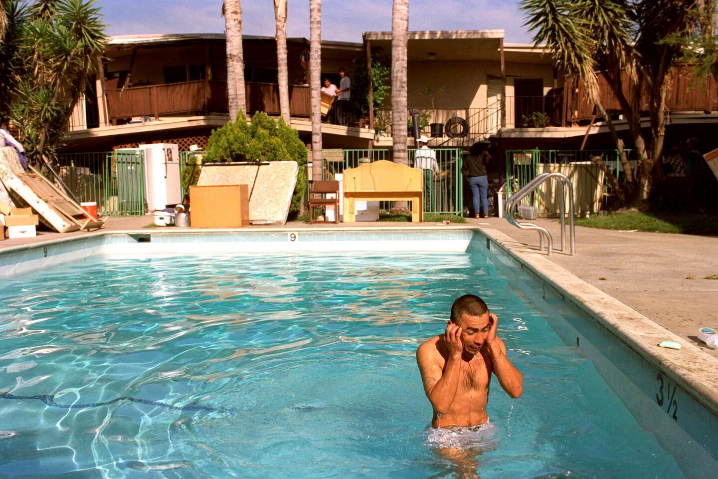 Unable to bathe since his Canoga Park apartment was condemned, Jose Aguilar rinses off in a pool.