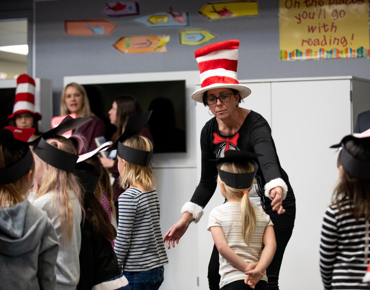 Kindergarten teacher Judy Barsh helps students line up for a recital of "Green Eggs and Ham" on Thursday.