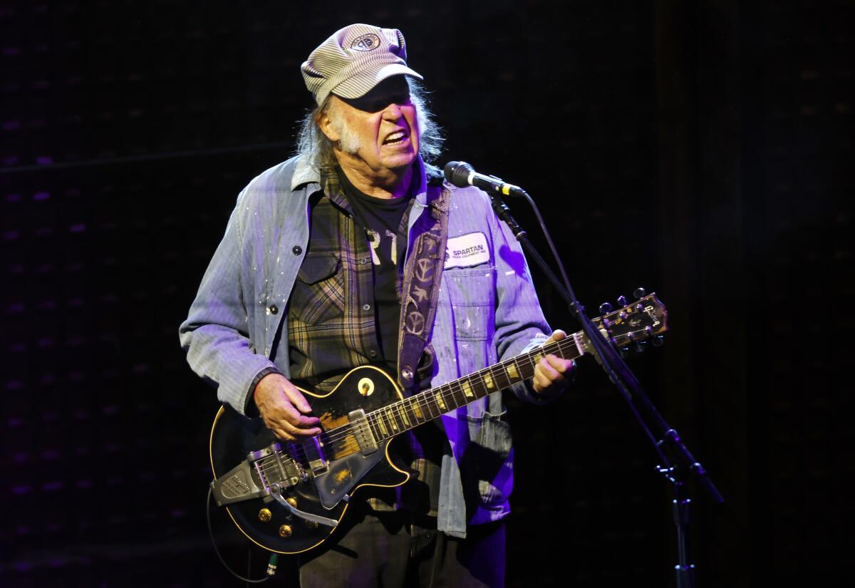 Neil Young performing at SDSU on April 24, 2024.