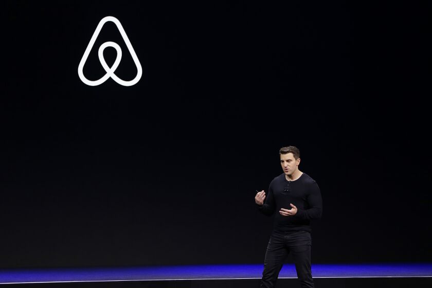 FILE - In this Feb. 22, 2018, file photo Airbnb co-founder and CEO Brian Chesky speaks during an event in San Francisco. In a world where social distancing has become a part of life and people are staying home in hopes of avoiding the coronavirus, companies that have built their business on the sharing economy are struggling. Ride-hailing companies are laying off thousands of employees as their once-loyal customers stay indoors. Those who venture out fear infection, and try to limit contact with others to minimize risk. And home-sharing apps such as Airbnb are slashing staff as the thought of opening living spaces to strangers begins to feel like an anachronism. (AP Photo/Eric Risberg, File)