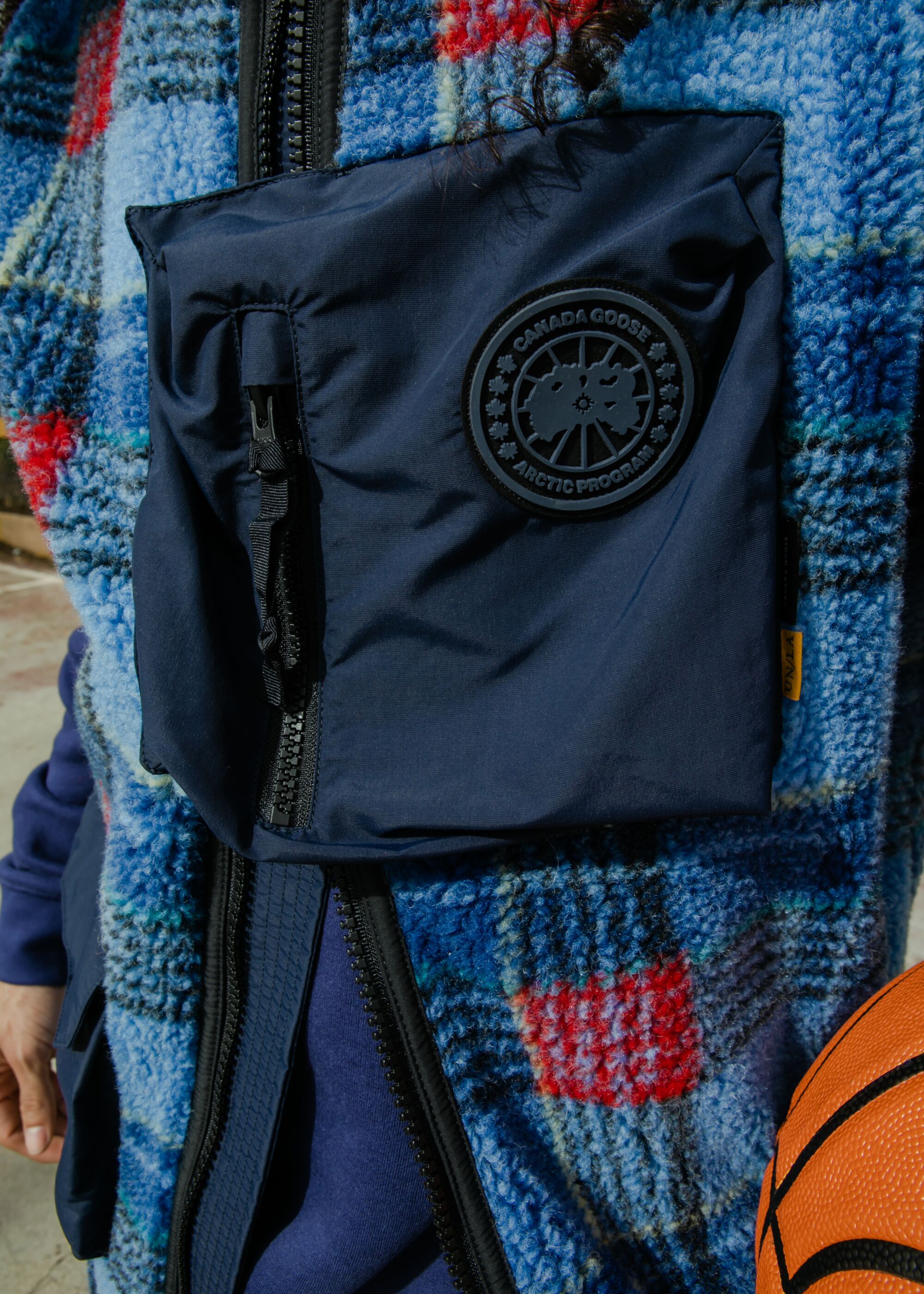 Close-up of a blue tartan vest with a solid blue panel.