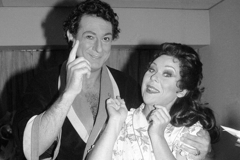 Placido Domingo appears with soprano Renata Scotto prior to a 1981 opening night at the Metropolitan Opera House in New York