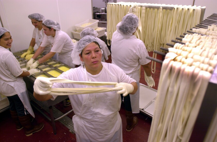 Workers make string cheese in the Karoun cheese plant in Hollywood.