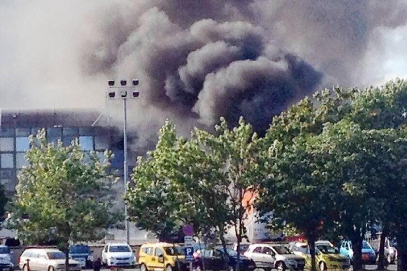 Smoke can be seen over the airport in Burgas, Bulgaria, where a tour bus carrying Israeli vacationers exploded, killing at least seven people.