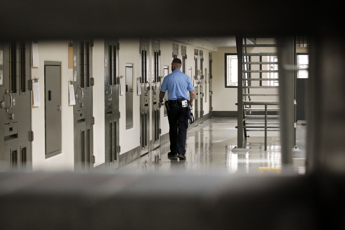 A guard patrols the Adelanto detention facility. 