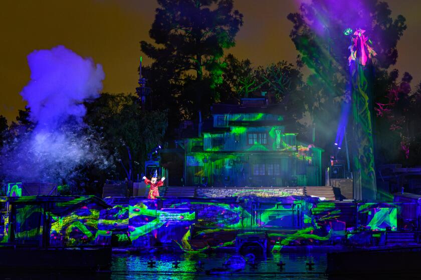 Mystical green projections emerge around Mickey Mouse in "Fantasmic!"