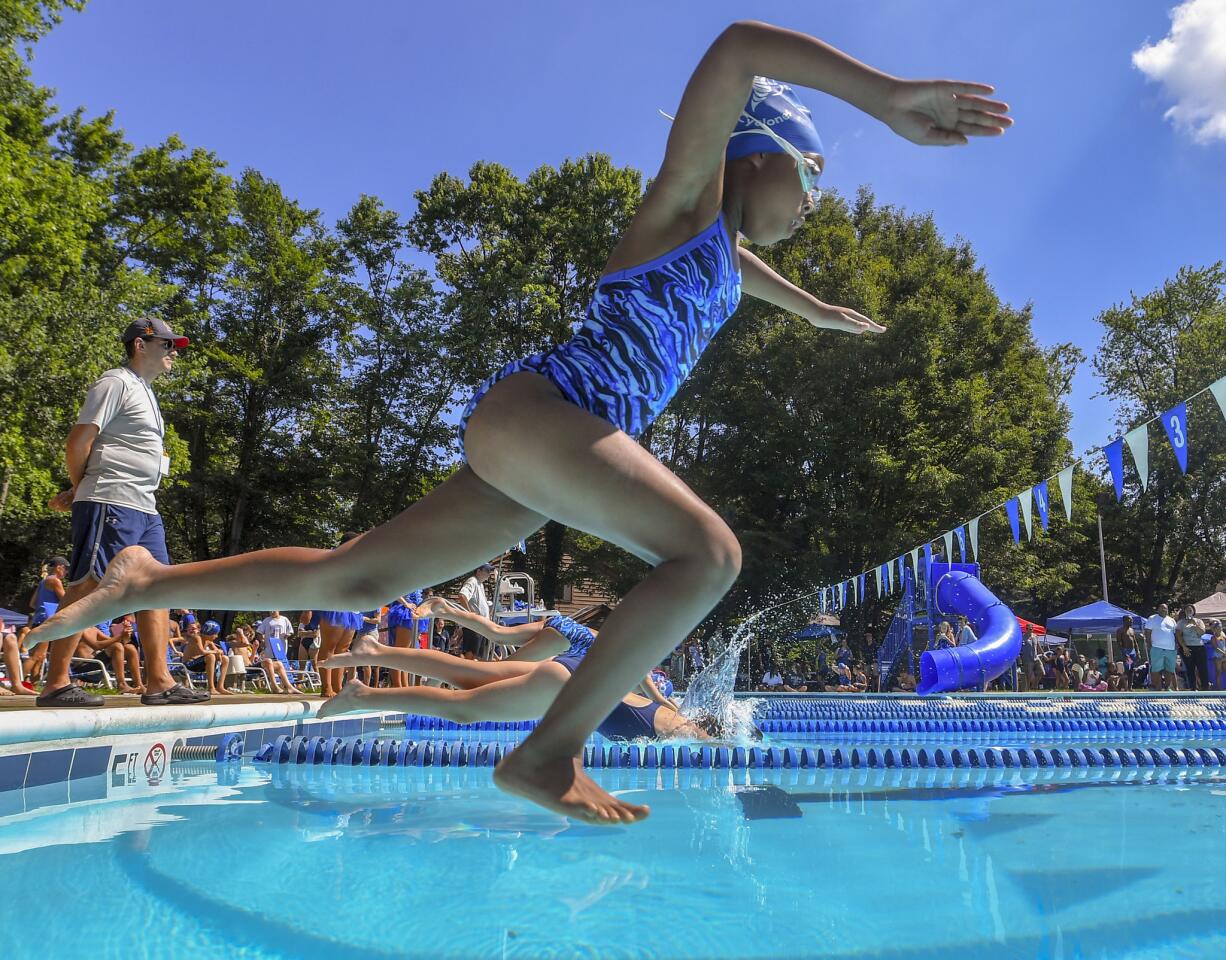 Clemens Crossing's Noelle Herry takes a running leap into the pool during her heat of the 9-10 25 yard breaststroke at the Columbia Neighborhood Swim League meet between host Clemens Crossing and Harper's Choice Saturday morning in Columbia.