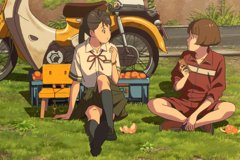 Suzume and Chika sitting on a patch of grass eating tangerines