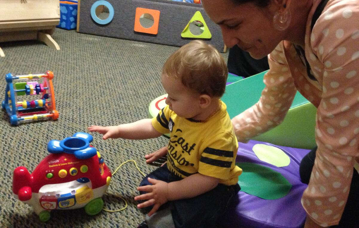 Single mother Beth Capper plays with her son Ezekiel Goss at the Children's Institute Inc.'s Mid-Wilshire campus in July.