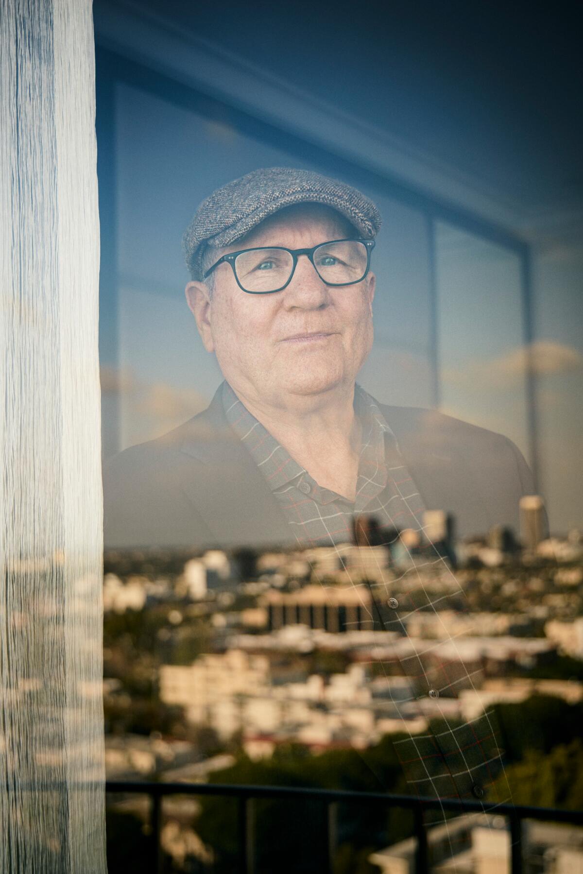 A man looks out a window on Los Angeles.