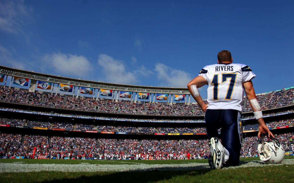 San Diego Chargers Quarterback Philip Rivers kneels before fans in a packed Qualcomm Stadium in 2011  