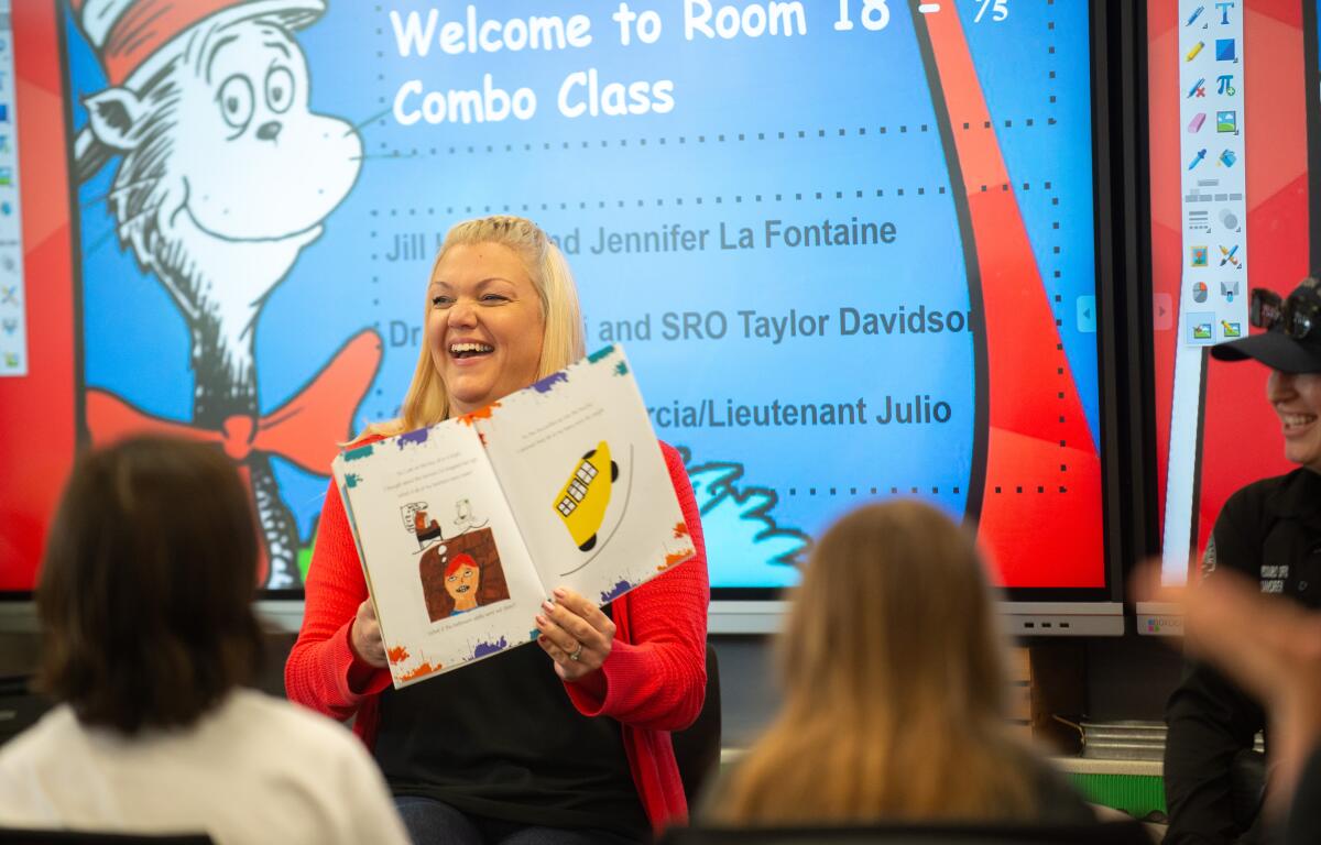 Dwyer Middle School Principal Christa Glembocki laughs while reading stories at Peterson Elementary School on Friday.