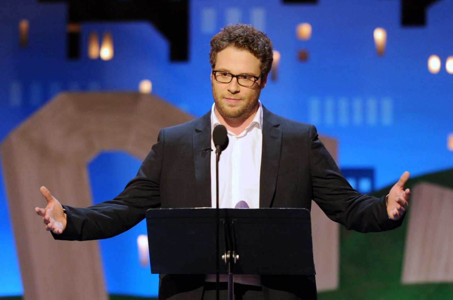 Seth Rogen may have gotten his start as a stand-up comedian, but it's by no means the way he pays the bills. That said, the "50/50" star held his own on the Independent Spirit Awards stage, battling the sounds of the munching audience and helicopters to both put down the show -- "You know you're at a really wonderful award show when you have to use a Porta Potty" -- and celebrate it.