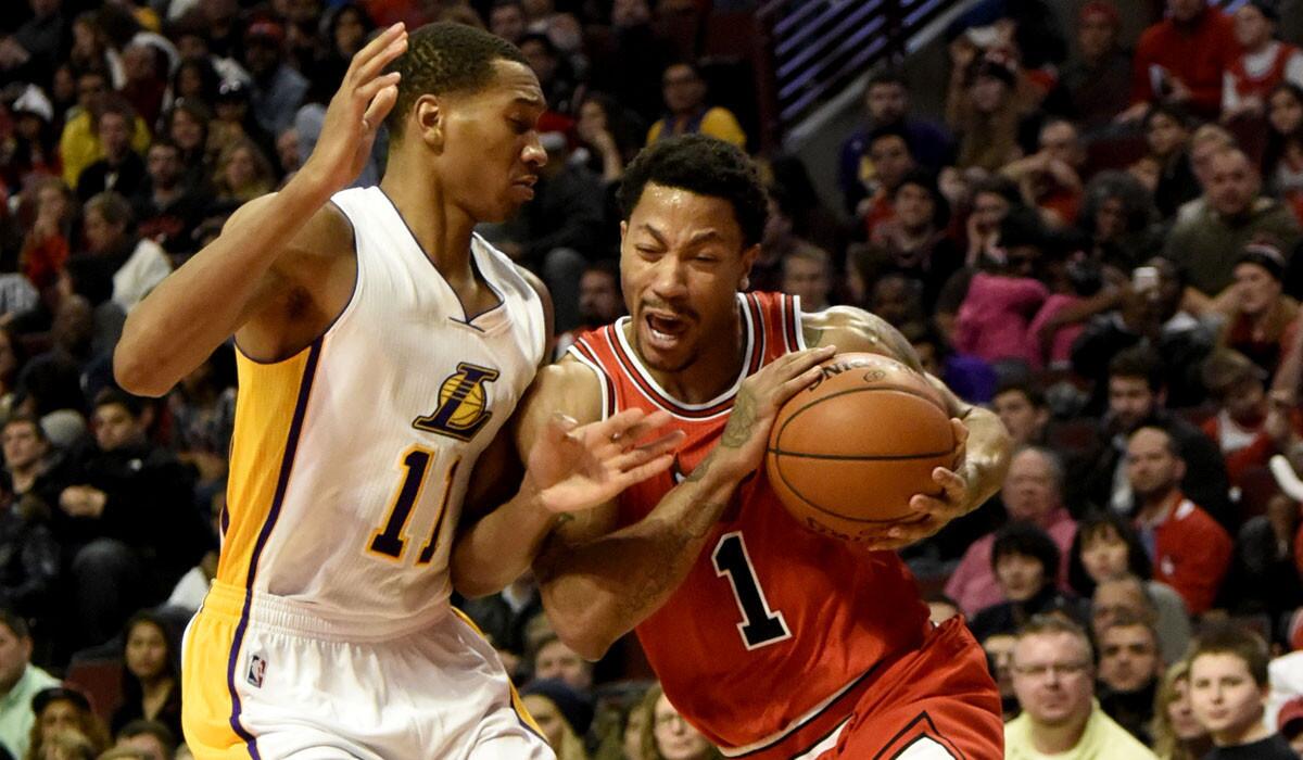 Lakers forward Wesley Johnson tries to cut off a drive by Bulls point guard Derrick Rose in the second half.