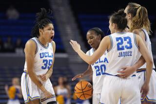 UCLA guard Camryn Brown, left, celebrates with teammates guard Charisma Osborne.