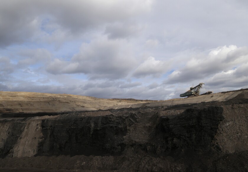 File - In this file photo taken on Thursday, Nov. 12, 2015 near the town of Most, Czech Republic, a huge excavator stands inside a giant open pit lignite mine. On Friday Jan. 7, 2022, the new Czech government pledged to work for the country to be able to phase out coal as an energy source by 2033. (AP Photo/Petr David Josek/File)