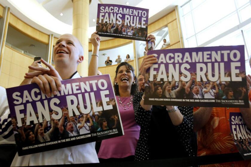 Sacramento Kings fans at City Hall celebrate the announcement that the team has been sold to investors who won't move the club.
