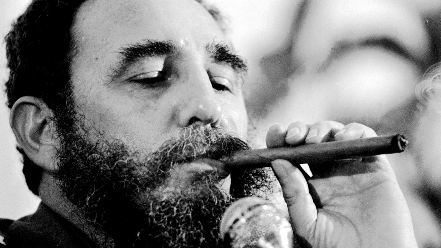 Fidel Castro enjoys a Cohiba cigar during a ceremony at the Palace of Receptions in Havana.