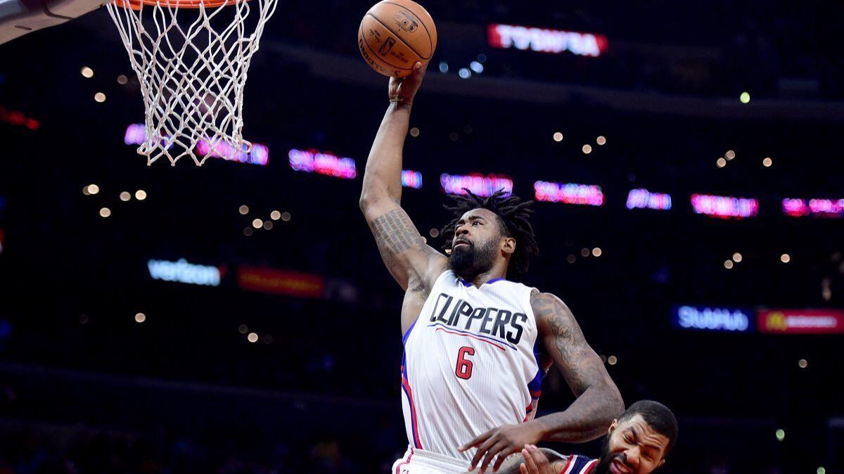 Clippers' DeAndre Jordan (6) dunks over Washington Wizards' Markieff Morris during a 133-124 Clippers' win on Wednesday.