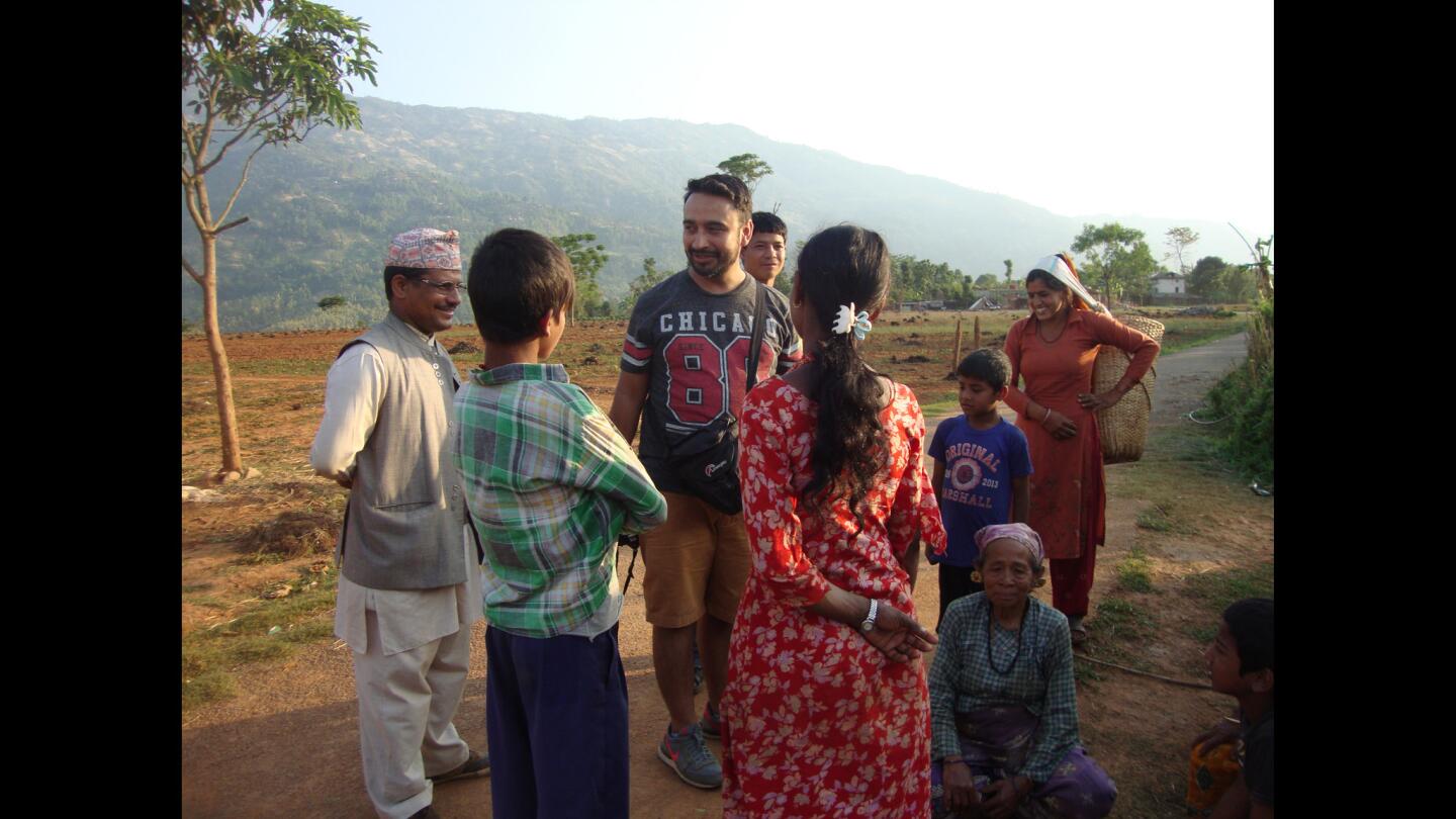 Jay Poudyal, 35, speaks with people in Nuwakot, known for hot, dry foothills so inhospitable that one town is called Bidur, or widow.