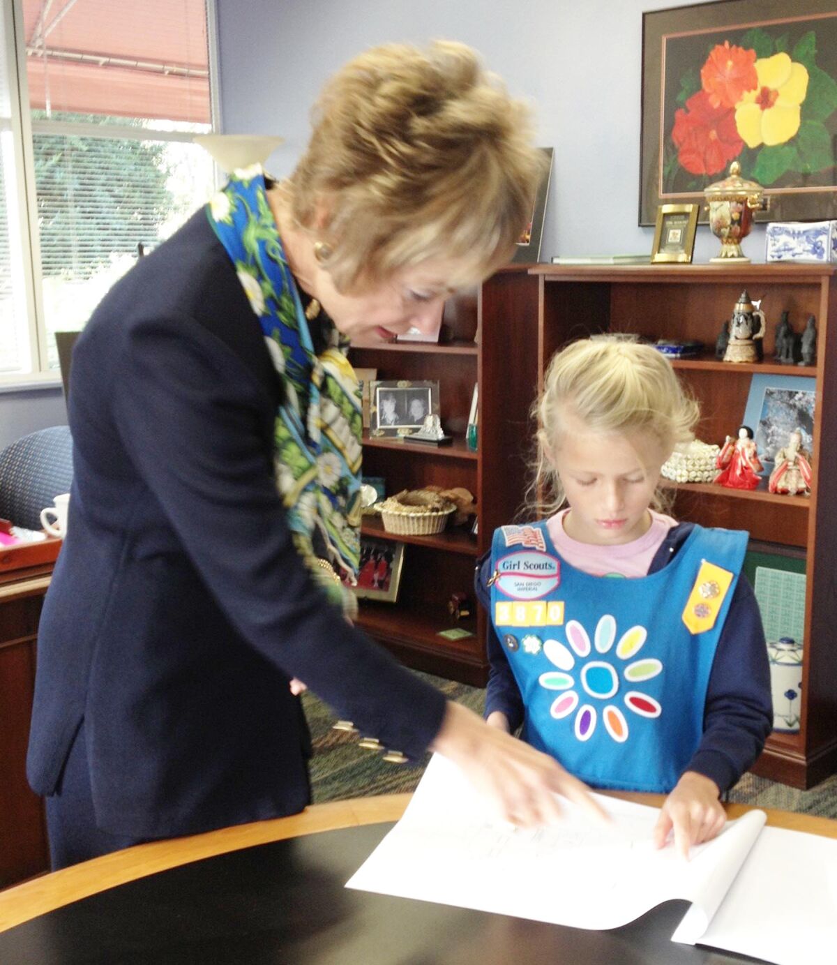 Former Girl Scouts San Diego CEO Jo Dee Jacob talking about a project with then-Daisy Girl Scout Daphne Jones.