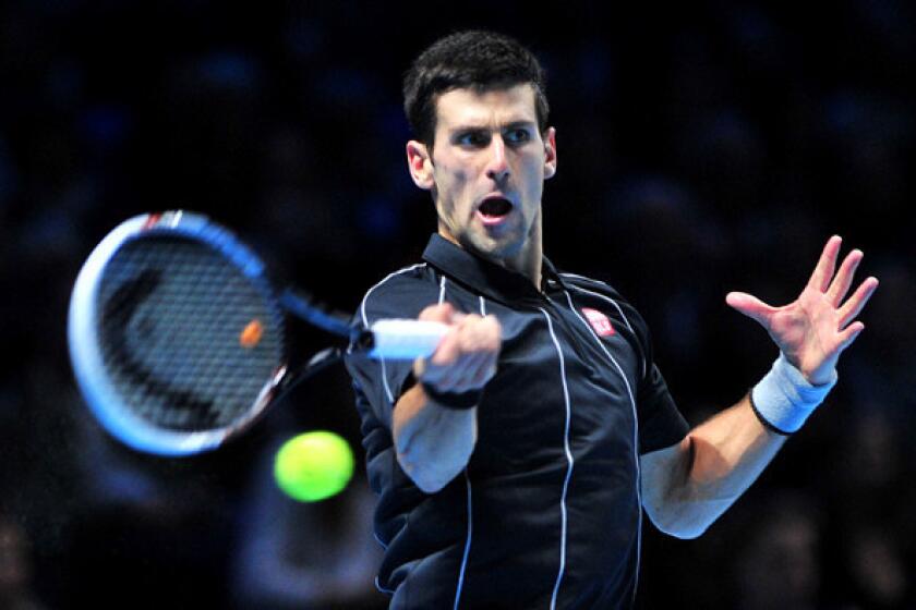 Novak Djokovic returns a shot against Stanislas Wawrinka in the semifinals of the ATP World Tour Finals in London on Sunday.