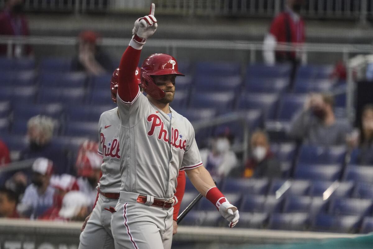 Philadelphia Phillies' Bryce Harper celebrates his solo home run during the first inning of a baseball game against the Washington Nationals at Nationals Park, Tuesday, May 11, 2021, in Washington. (AP Photo/Alex Brandon)