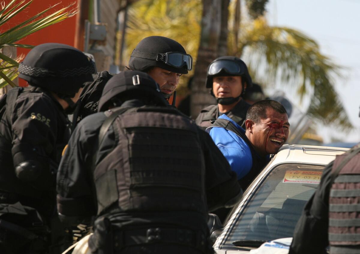 A man is detained by police Saturday after workers of tomato farm labor camps allegedly invaded private property, according to state police in San Quintin, Mexico.