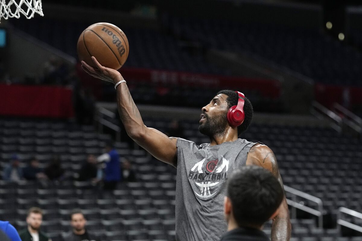 Dallas Mavericks guard Kyrie Irving warms up prior to an NBA basketball game against the Los Angeles Clippers Wednesday, Feb. 8, 2023, in Los Angeles. (AP Photo/Mark J. Terrill)