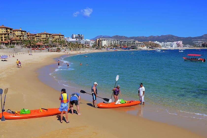 MEXICO, CABO SAN LUCAS: Medano Beach, Cabo San Lucas, is a hub of daytime activities from waterspouts to restaurants.