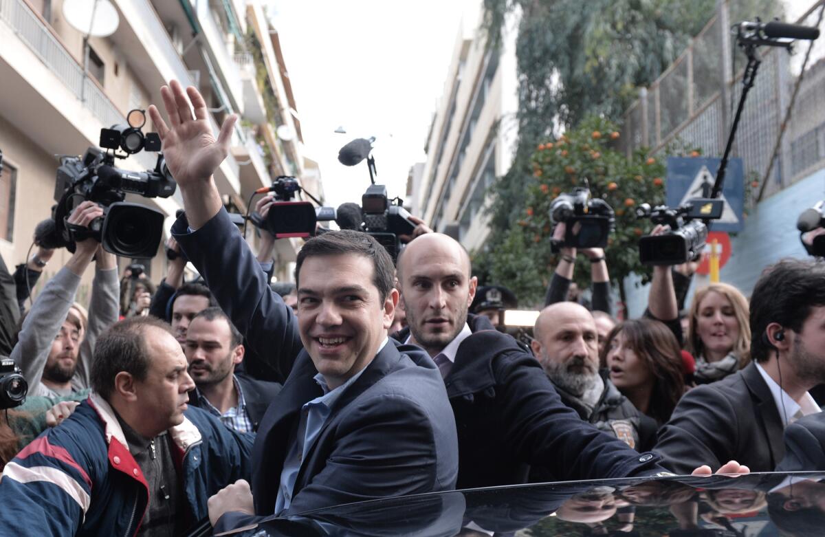 The leader of Greece's left-wing Syriza party, Alexis Tsipras, leaves a polling station in Athens.