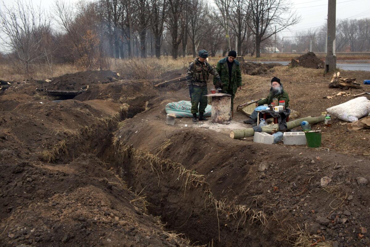 Pro-Russia gunmen camped out Nov. 13 by the trenches they have dug in a northwest suburb of Donetsk, in eastern Ukraine, in anticipation of renewed fighting against government forces.