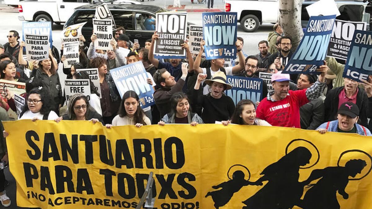 About 100 people demonstrate outside a federal immigration court in Los Angeles.