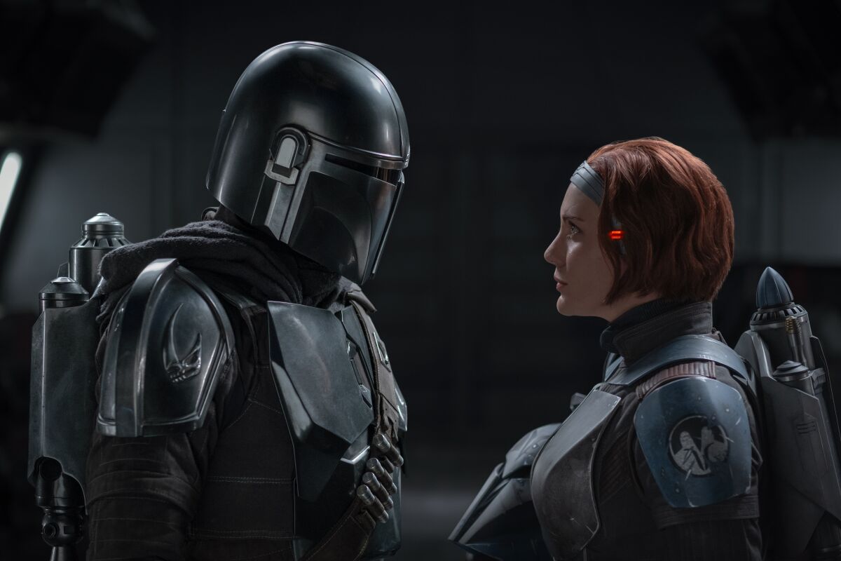Pedro Pascal and Katee Sackhoff facing each other