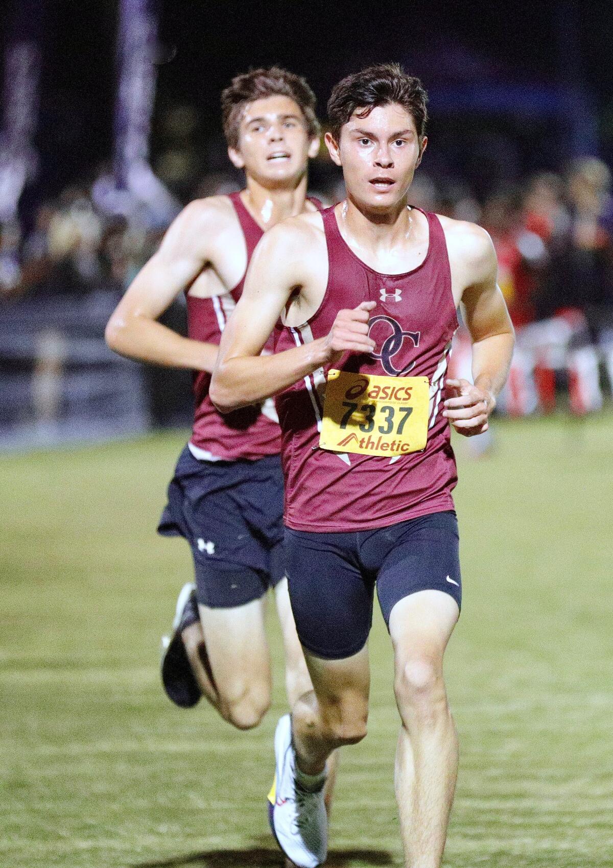 Oaks Christian teammates Christian Yoder (front) and Cooper McNee run at the Woodbridge Cross Country Classic.