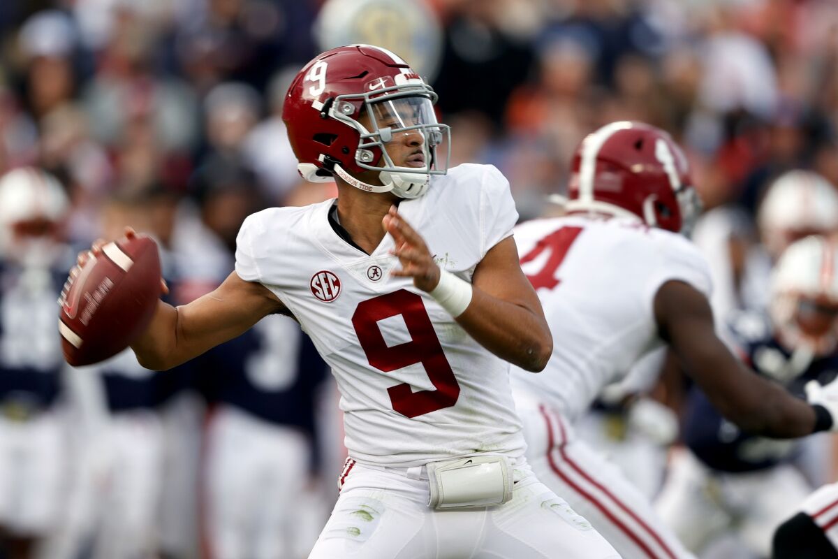 FILE - Alabama quarterback Bryce Young (9) throws a pass against Auburn during the first half of an NCAA college football game, Nov. 27, 2021, in Auburn, Ala. Young has been selected as an All-American by The Associated Press, giving the top-ranked Crimson Tide more players on the first team than any other school. (AP Photo/Butch Dill, File)