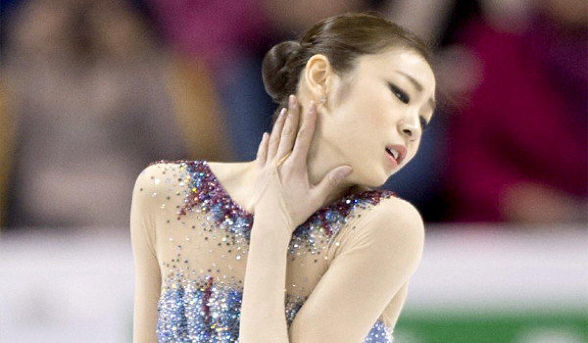 Yuna Kim earned a first place finish on a 69.97 performance in the short program at the Figure Skating World Championships in Canada.