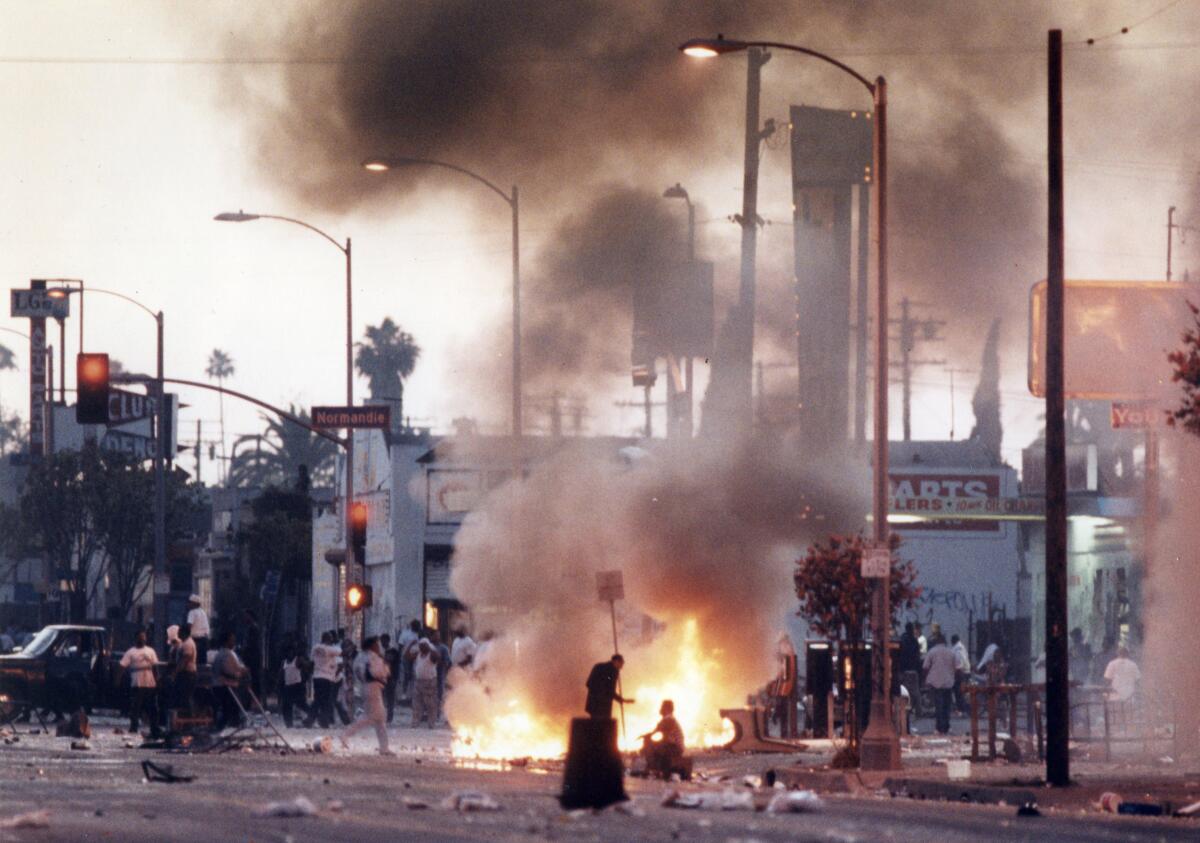 Rioters roam the streets on the first day of the L.A. riots on April 29, 1992.