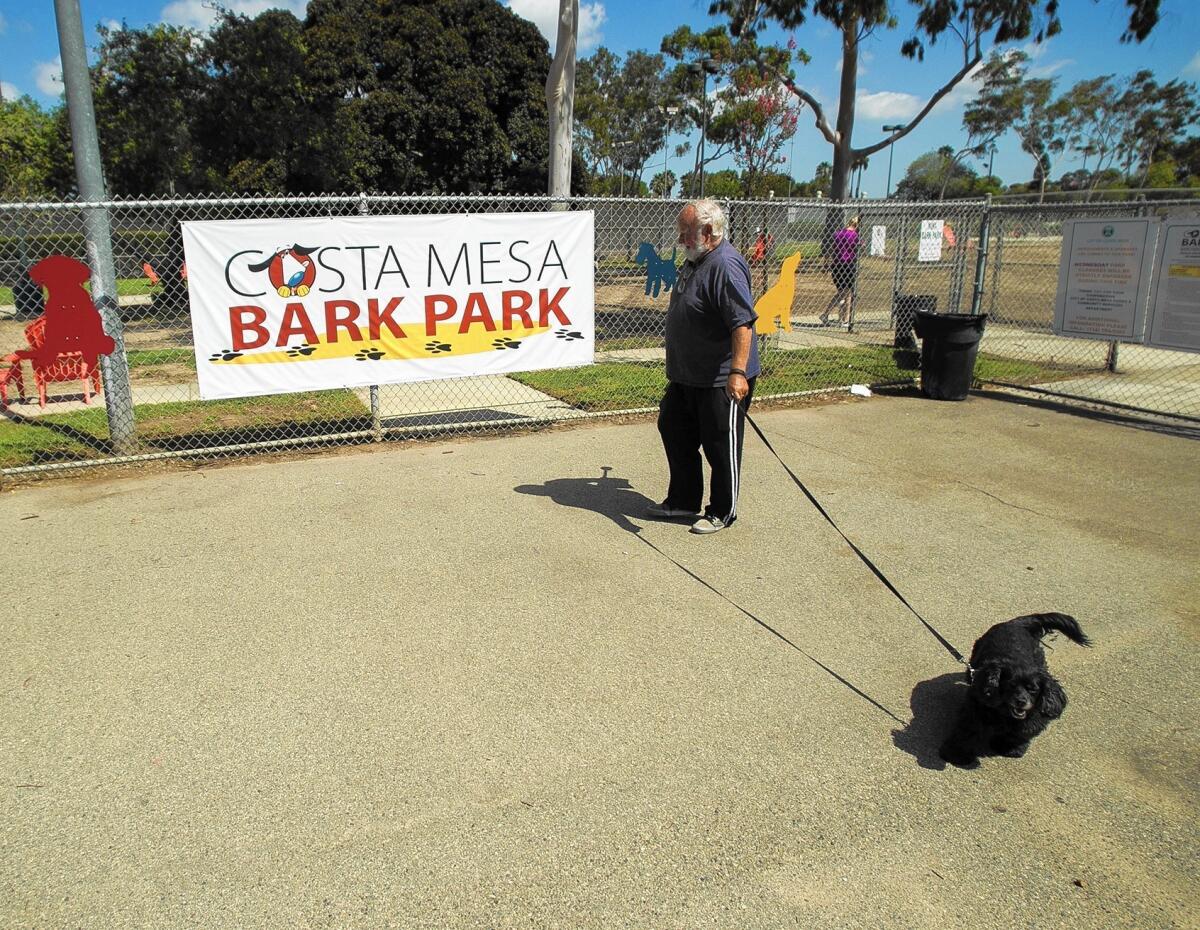 Richard Reinbolt walks his dog Marae at the Costa Mesa Bark Park in September. The Bark Park's small-dog section is expected to be closed until mid-June while renovations are done.