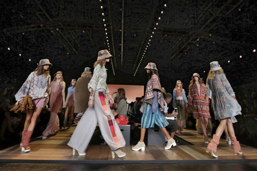 BCBG Max Azria said it is laying off employees a few months after an interim chief executive took over. Above, models at New York Fashion Week show the brand's spring 2016 collection.