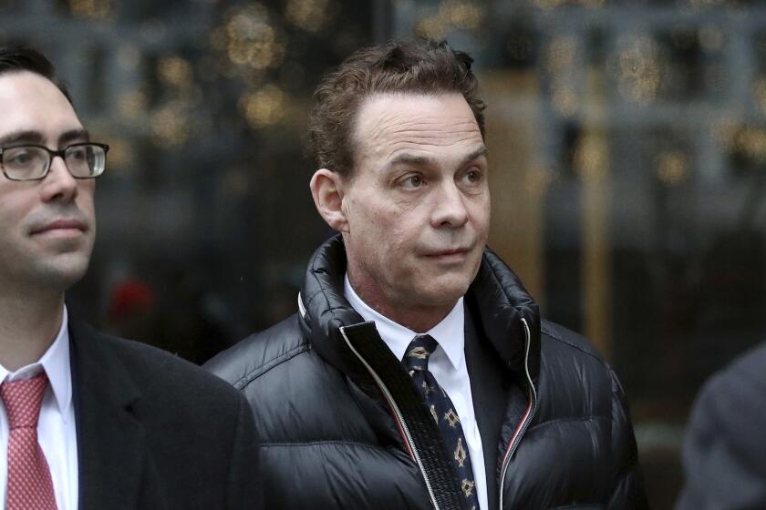 In this March 27, 2019, photo, Robert Zangrillo departs federal court in Boston after a hearing in a nationwide college admissions bribery scandal. Lawyers for Zangrillo plan to argue that he isn’t much different from parents who make formal donations to schools in the hopes of giving their children an edge in admissions. (Craig F. Walker/The Boston Globe via AP)