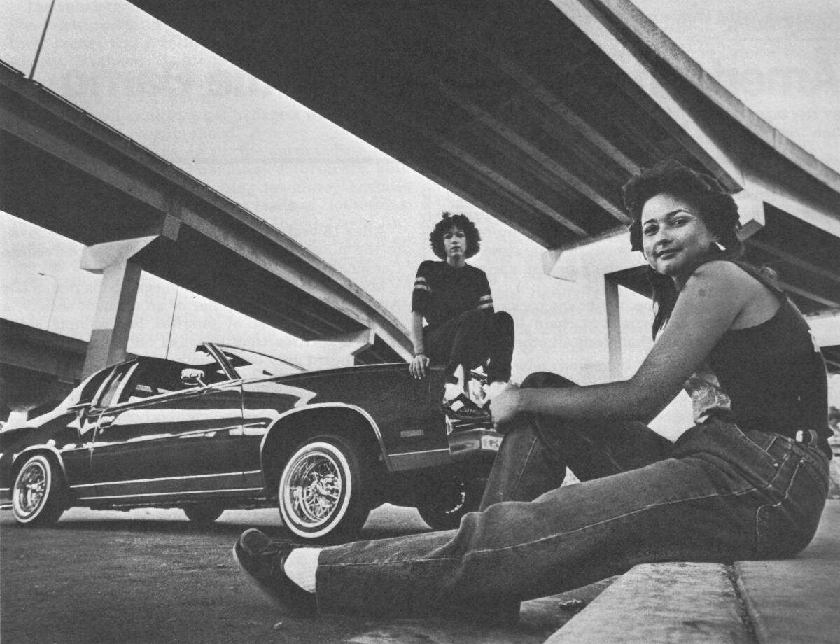 Beneath the Coronado Bridge, Monica Cruz, front, and Marina Garcia visit Chicano Park. 