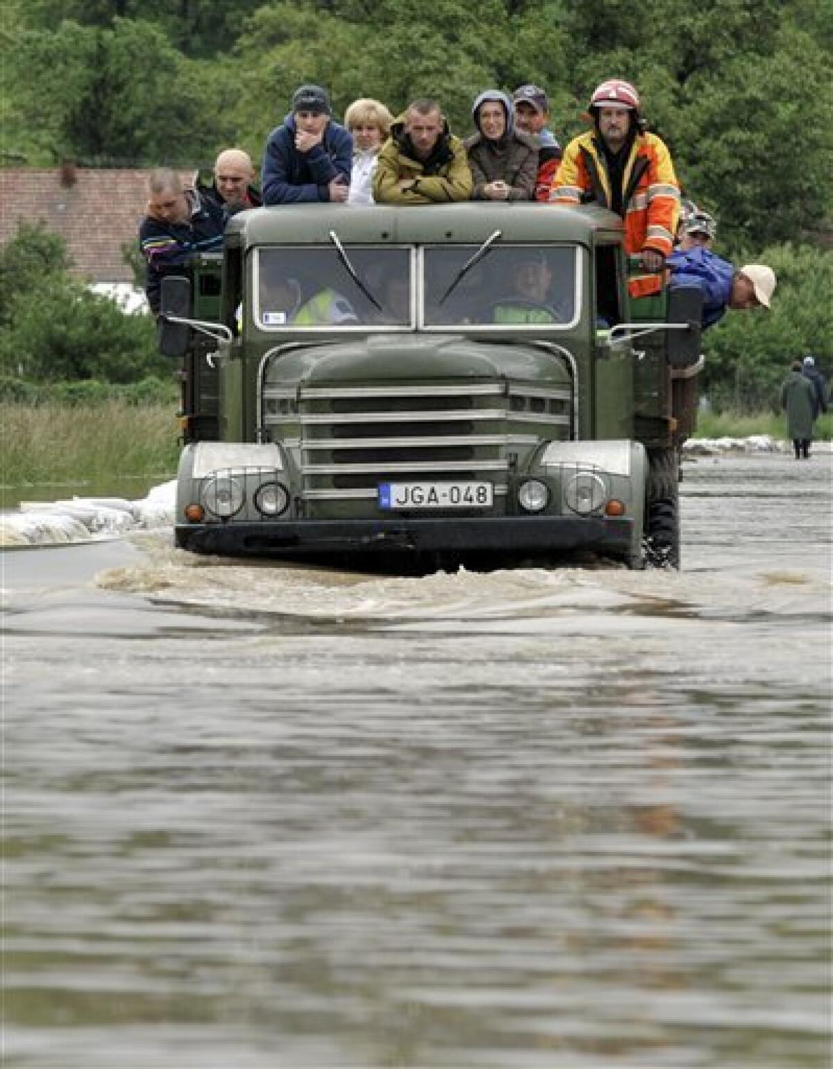 Villagers are being evacuated through an over-flooded road after the rising water surrounded their houses in Kiskinizs, northeastern Hungary, Tuesday, May 18, 2010. Several swollen rivers causing floods throughout Hungary, while roads remain closed due to the unusual wet weather and heavy rains. Heavy rains that began in central Europe last weekend also are causing flooding in areas of Poland , Slovakia and the Czech Republic, with rivers bursting their banks and inundating low-lying homes and roads, and cutting off villages. (AP Photo/Bela Szandelszky)
