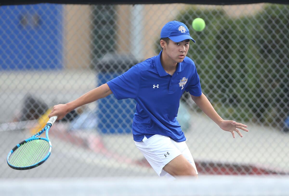 Fountain Valley singles player Ben Nguyen hits a backhand drop shot in a nonleague match against Beckman on Thursday.