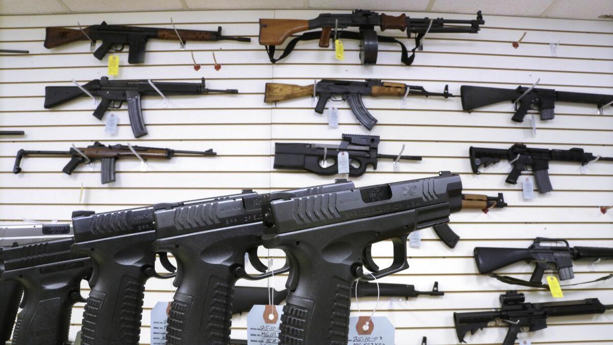 In this Jan. 16, 2013, file photo, assault weapons and handguns are seen for sale at Capitol City Arms Supply in Springfield, Ill.