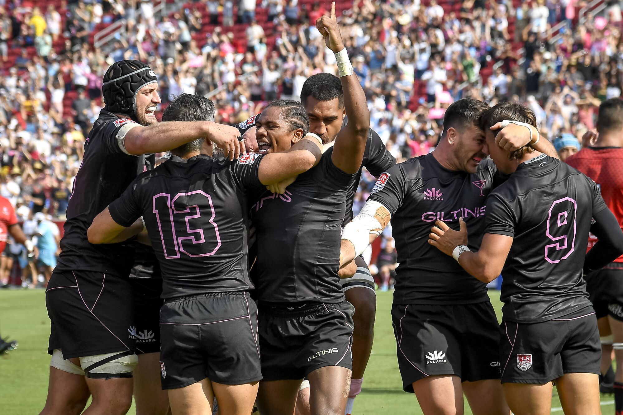 Giltinis teammates celebrate with Ryan James after he scored a try against the Utah Warriors in the second half.