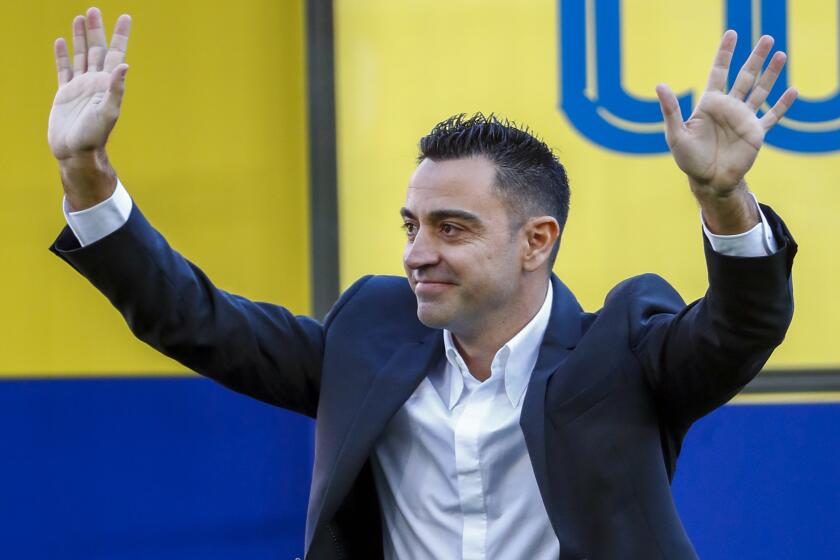 FC Barcelona's new coach Xavi Hernandez gestures during his official presentation at the Camp Nou stadium in Barcelona, Spain, Monday, Nov. 8, 2021. Xavi, who thrived in Barcelona’s midfield alongside Messi and Andres Iniesta, was officially introduced as coach on the field of the Camp Nou with a reception usually only offered to top players. (AP Photo/Joan Monfort)