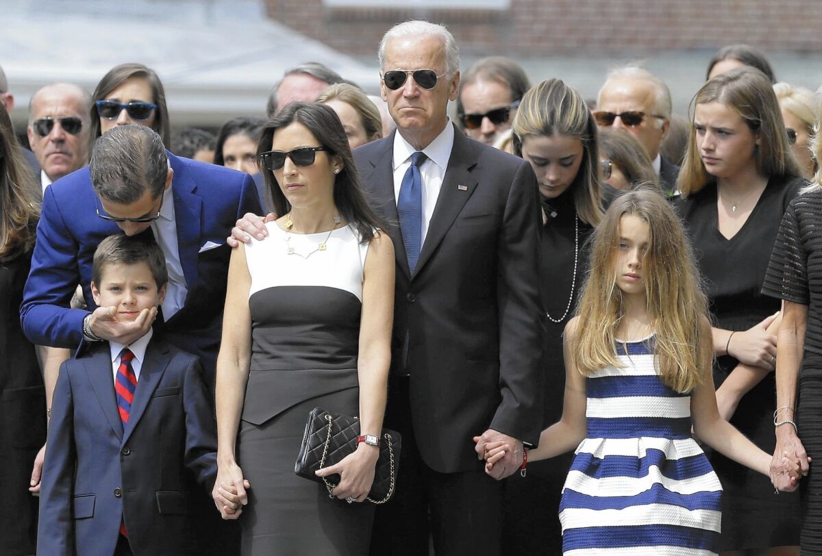 Vice President Joe Biden, center, before son Beau’s funeral in June, with family members including Beau’s widow, Hallie, and children Hunter and Natalie, in front.