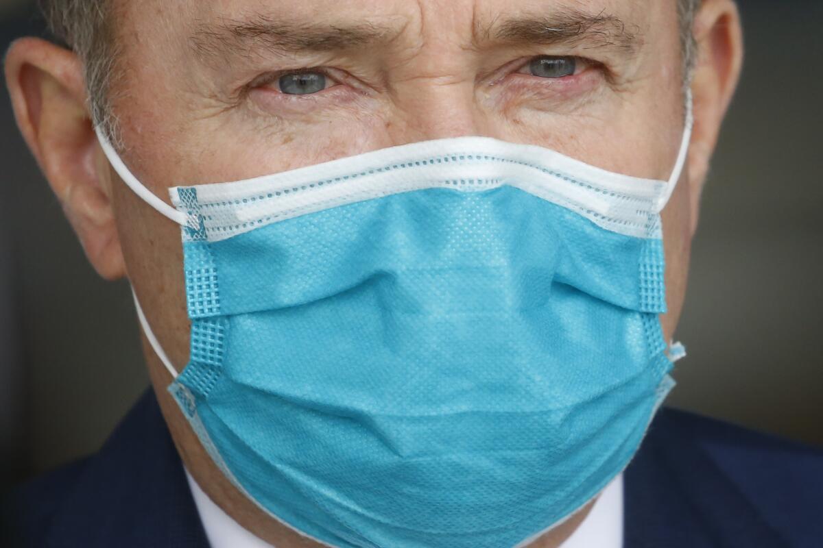 Utah Gov. Gary Herbert wears a mask during a news conference in Salt Lake City in April.